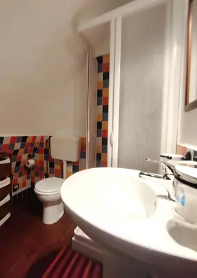 a bathroom with a white sink and a toilet at Room in Villa Galletti Inguaggiato in Bagheria