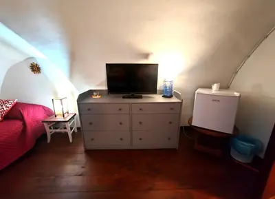 a bedroom with a dresser with a television on it at Room in Villa Galletti Inguaggiato in Bagheria