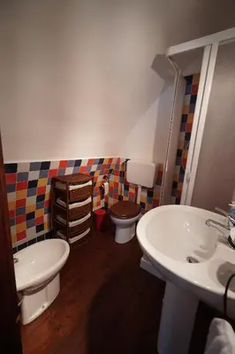 a bathroom with a toilet and a sink at Room in Villa Galletti Inguaggiato in Bagheria