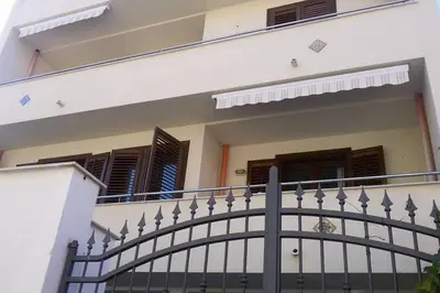 a balcony of a house with a black fence at King's Residence in Balestrate