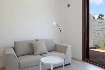 a living room with a couch and a table at Villa Memi in Cefalù