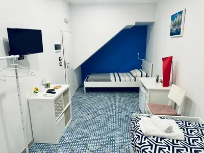 a small room with a bedroom with a bed and a staircase at Corleone Home in Corleone