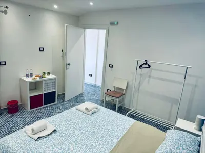 a bathroom with a shower and a bed and a chair at Corleone Home in Corleone