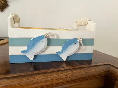 two dolphins in a wooden box on a table at A CASA DEL CONSOLE in Mondello