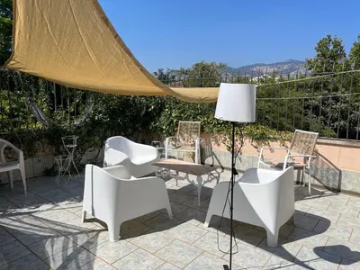a patio with chairs and a table and a lamp at A CASA DEL CONSOLE in Mondello