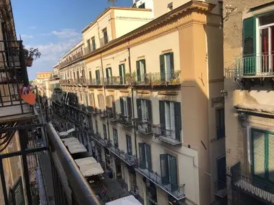 an apartment building with balconies on a city street at City Center Apartment da FeLù in Palermo
