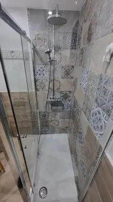 a bathroom with a shower with a glass door at Il quaRtetto apartment in Palermo