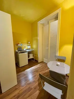 a yellow room with a table and a chair in it at MATTI X 2 in Palermo