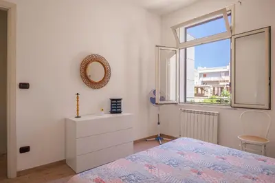 a bedroom with a bed and a window and a dresser at Casa Ferrito - Porticello in Porticello
