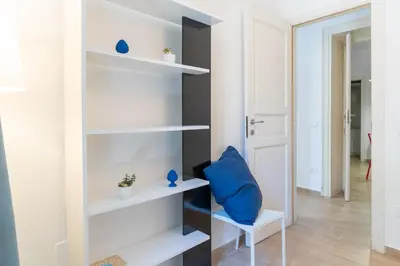 a room with white shelves and a blue pillow at Four Luxury Apartment in Palermo