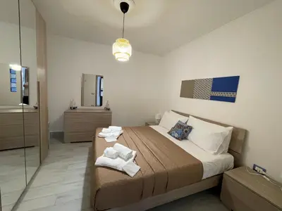 a bedroom with a bed with towels on it at Tampasiando in Cinisi