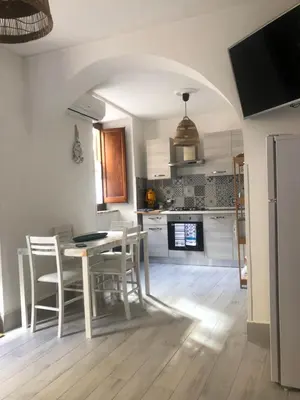 a kitchen with a table and chairs in a room at Tampasiando in Cinisi