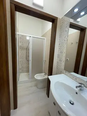 a bathroom with a sink and a toilet and a mirror at Civico 356 in Castellammare del Golfo