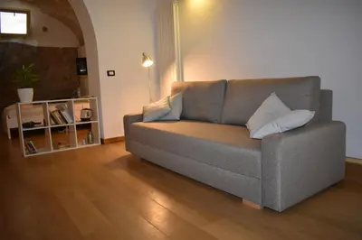 a living room with a couch with pillows on it at Casa Selinunte in Palermo