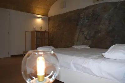 a room with a bed with a candle on a table at Casa Selinunte in Palermo