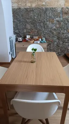 a wooden table with a plant in a vase on it at Casa Selinunte in Palermo