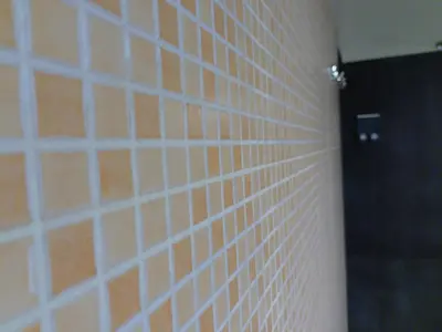 a bathroom with white tile walls and a black door at Antadia in Palermo