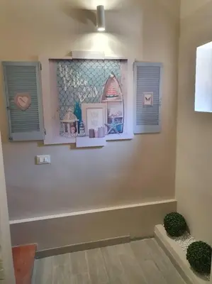 a room with three windows with pictures on the wall at Demma' s DIAMOND in Palermo