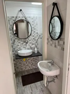 a bathroom with a sink and a mirror at Spasimo Boutique in Palermo