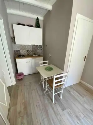 a kitchen with a table and chairs in a room at Spasimo Boutique in Palermo