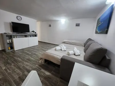 a living room with a couch and a flat screen tv at Don Vito's Home, DsG2 Short Lets, 250 mt Metrò in Palermo