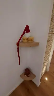 a santa hat on a wall with two shelves at A CASA DI ELENA in Palermo