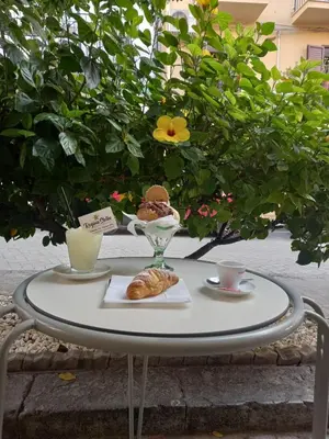 a table with a plate of food and a pastry at Regina Stella in Lascari