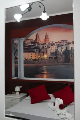 a bedroom with a picture of a city at Regina Stella in Lascari