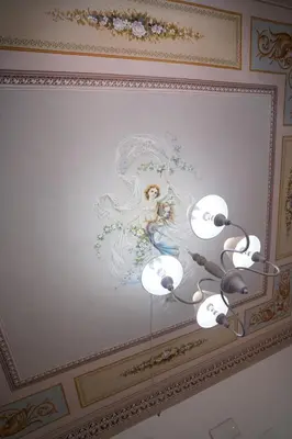 a painting of an angel on the ceiling of a room at Regina Stella in Lascari