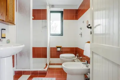 a bathroom with a toilet and a sink at Isulidda Gaia Mare in San Vito lo Capo