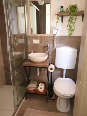 a bathroom with a toilet and a sink and a shower at Le Due Perle in Palermo