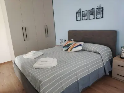 a bedroom with a bed with two towels on it at La Nicaredda in Alcamo