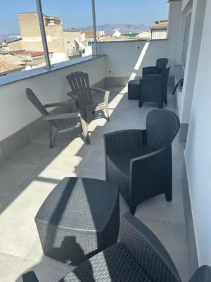 a patio with chairs and tables on a balcony at La Nicaredda in Alcamo