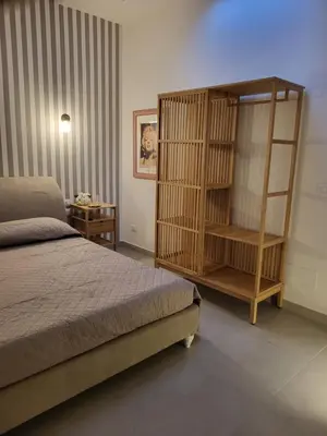 a bedroom with a bed and a side table at Malaspina Cico Suite in Palermo