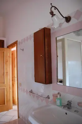 a bathroom with a sink and a mirror at Cinisi 89 B&B in Cinisi