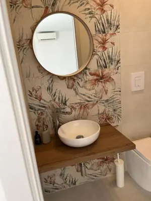 a bathroom with a sink and a mirror on a wall at Villa Capri Holiday Home in Campofelice di Roccella