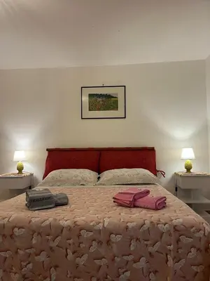 a bedroom with a bed with two towels on it at Casetta di Ale al Capo in Palermo