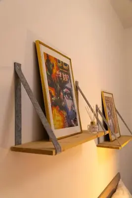 a shelf with paintings on it on a wall at Santa Cecilia House centro Palermo-350 mt stazione in Palermo