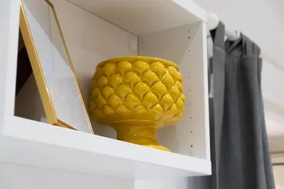 a yellow vase sitting on top of a shelf at Santa Cecilia House centro Palermo-350 mt stazione in Palermo