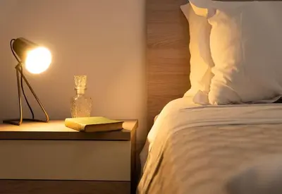 a bedroom with a bed with a lamp and a book at Santa Cecilia House centro Palermo-350 mt stazione in Palermo