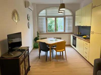 a kitchen with a table and chairs and a dining room at casa vacanze Mondello mare piscina CHIFEVI in Mondello