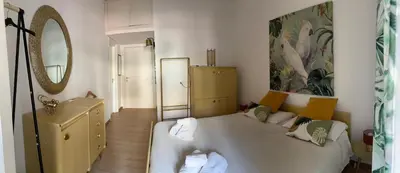 a bedroom with a large white bed and a mirror at casa vacanze Mondello mare piscina CHIFEVI in Mondello
