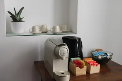 a coffee machine sitting on a wooden table at Il corvo e la volpe in Palermo