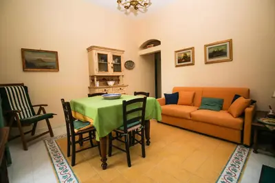 a living room with a table and a couch at Il Gelsomino in Palermo
