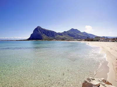 a beach with a mountain in the background at Holiday Home Acquamarina Gaia by Interhome in San Vito lo Capo