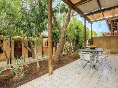 a patio with a table and chairs under a pergola at Holiday Home Acquamarina Gaia by Interhome in San Vito lo Capo