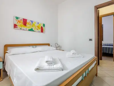a bedroom with a bed with towels on it at Holiday Home Acquamarina Gaia by Interhome in San Vito lo Capo