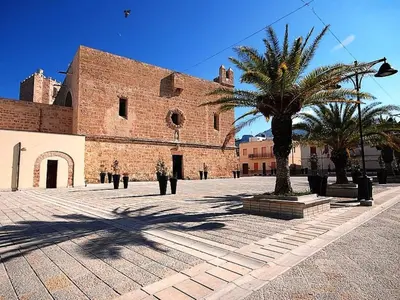 a large brick building with a palm tree in front of it at Holiday Home Acquamarina Gaia by Interhome in San Vito lo Capo