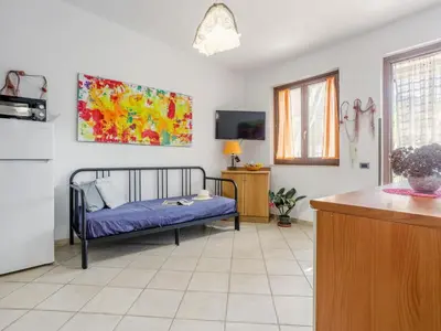 a living room with a bed and a kitchen at Holiday Home Acquamarina Gaia by Interhome in San Vito lo Capo