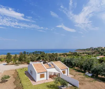 an aerial view of a house with the ocean in the background at Villa Beba in Cefalù